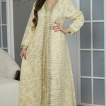 جلابيه اصفر بطبقه داخلي جاكار مزينه بشريط ذهبي مع فصوص